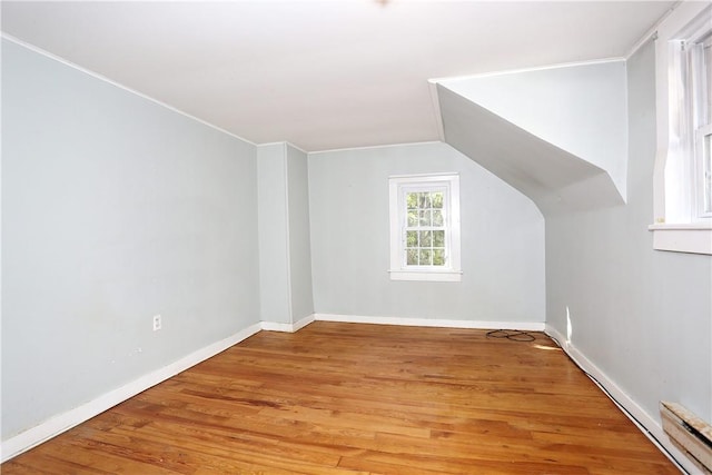 bonus room with vaulted ceiling and hardwood / wood-style flooring