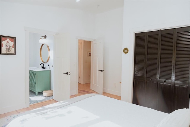 bedroom with light wood-type flooring and a closet