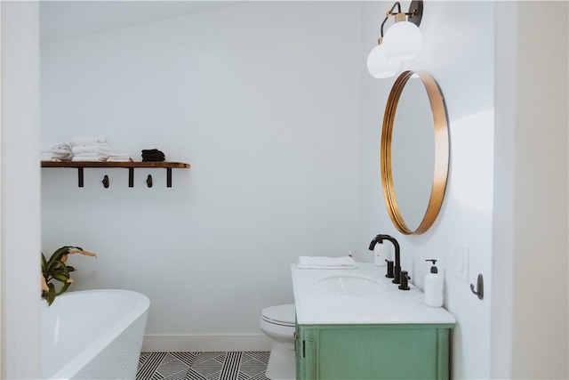 bathroom with tile patterned flooring, vanity, toilet, and a bathing tub