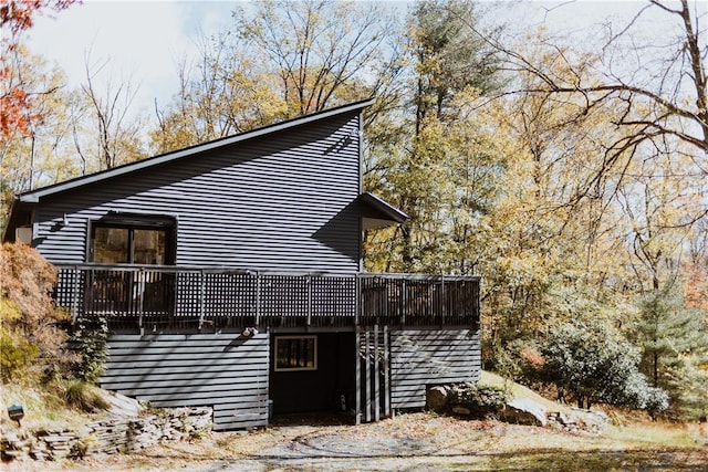 view of home's exterior featuring a wooden deck