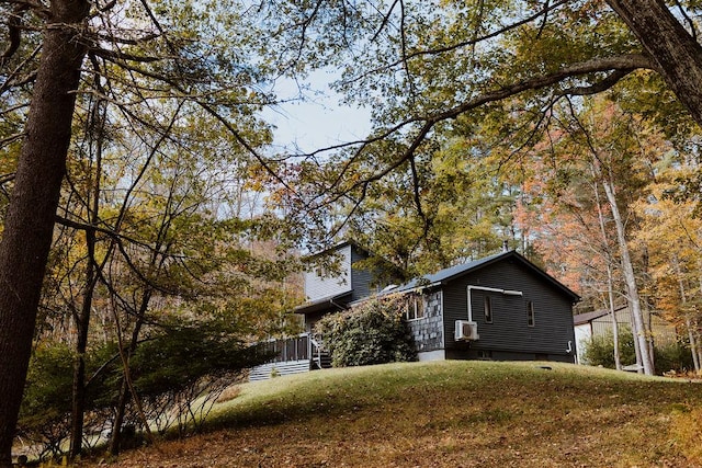 view of property exterior with a yard