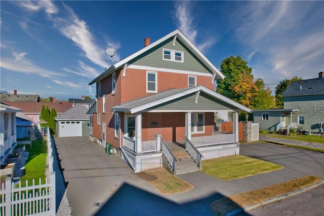 view of front of home with a garage, covered porch, and an outdoor structure