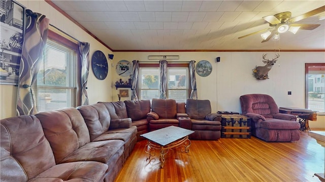 living room featuring crown molding, ceiling fan, and hardwood / wood-style flooring