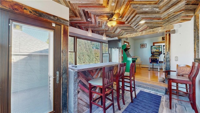 dining area with hardwood / wood-style floors, coffered ceiling, ceiling fan, ornamental molding, and beamed ceiling