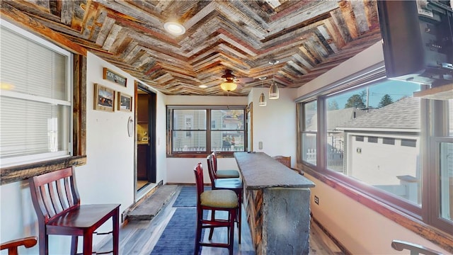 dining area with coffered ceiling, wood ceiling, dark wood-type flooring, crown molding, and beam ceiling