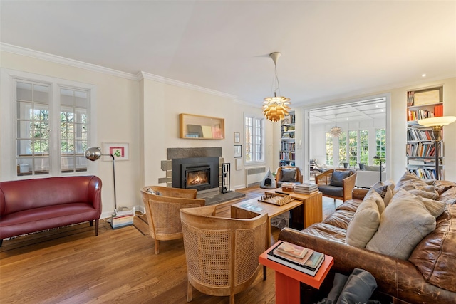 living room with crown molding and hardwood / wood-style flooring