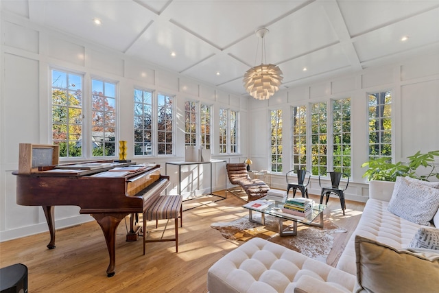 sunroom / solarium with coffered ceiling and a notable chandelier