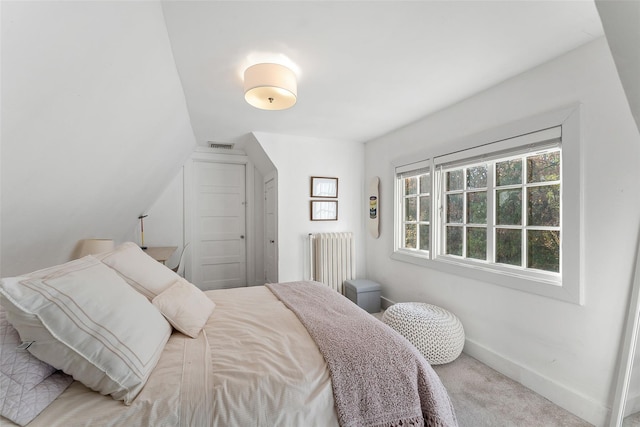 bedroom featuring radiator heating unit and carpet