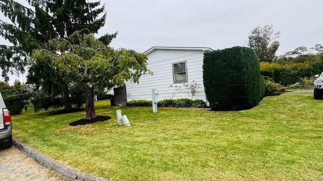 view of property exterior with a lawn