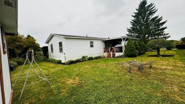 rear view of property featuring a yard