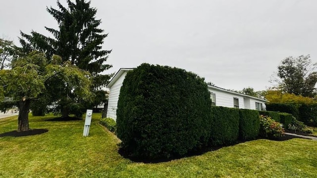 view of property exterior featuring a lawn