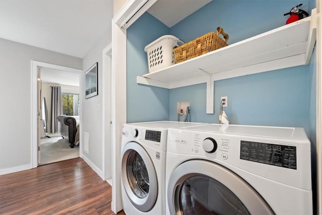 laundry area with dark hardwood / wood-style floors and independent washer and dryer