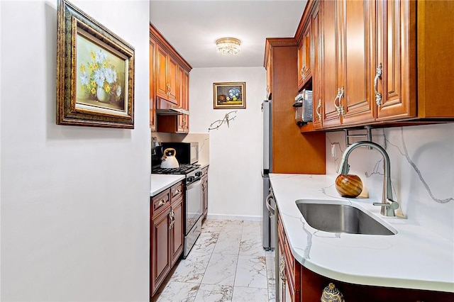 3333 Henry Hudson Pkwy Unit 1G, Bronx, NY 10463 - kitchen featuring gas stove, under cabinet range hood, a sink, light marble finish floors, and baseboards