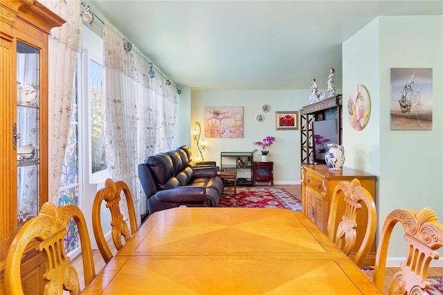 dining space with wood-type flooring