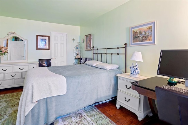 bedroom with dark parquet floors