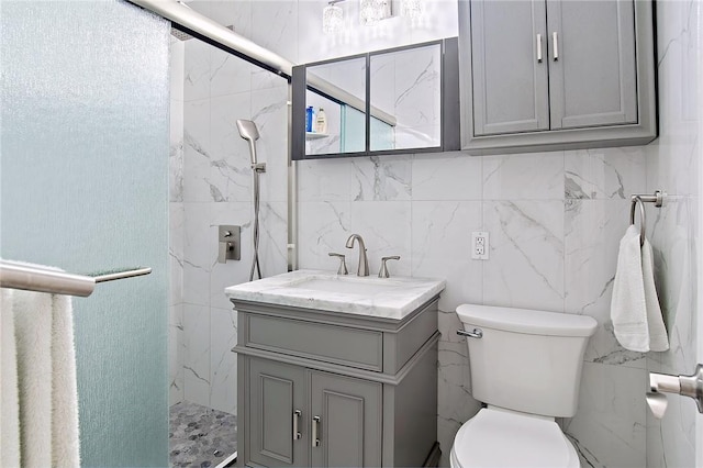 bathroom with walk in shower, vanity, toilet, and tile walls