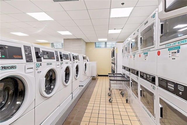 laundry room featuring independent washer and dryer, light tile patterned floors, and stacked washer / dryer