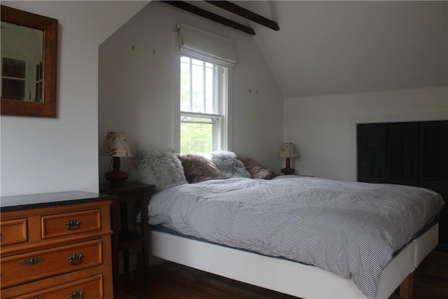 bedroom with lofted ceiling with beams and dark wood-type flooring