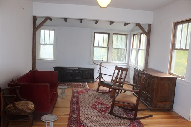 sitting room with beam ceiling and light hardwood / wood-style flooring