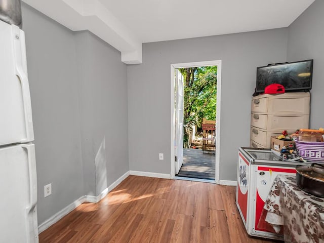 interior space with hardwood / wood-style floors and white fridge