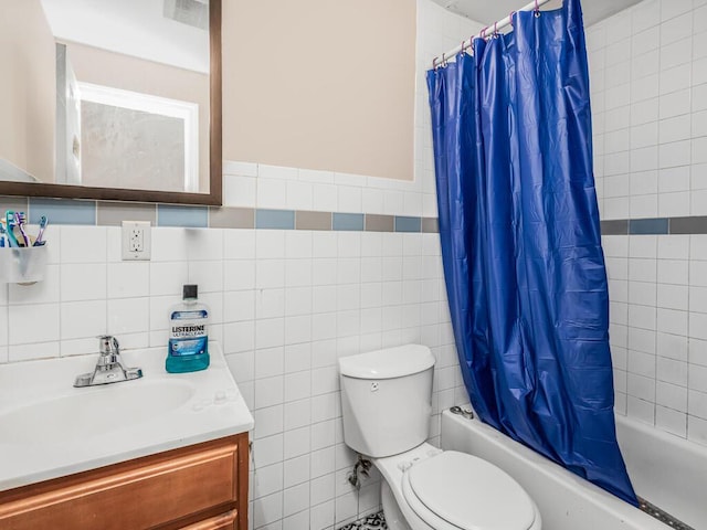 full bathroom with shower / tub combo with curtain, vanity, tile walls, and toilet