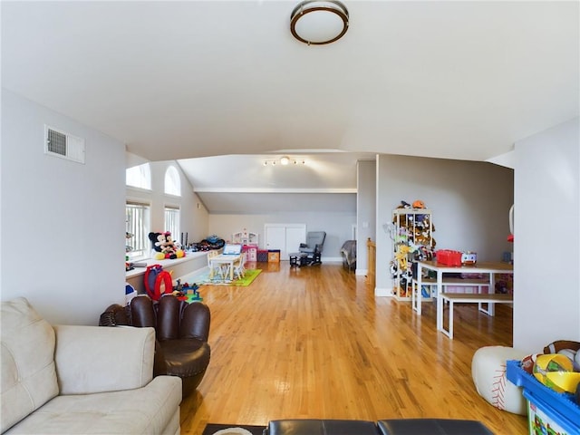 playroom featuring hardwood / wood-style flooring and vaulted ceiling