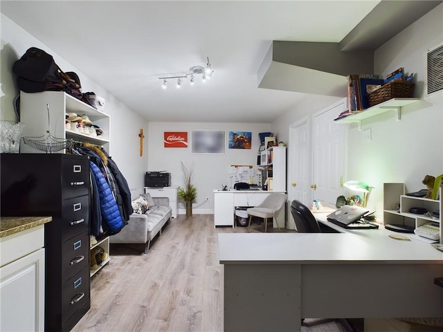 home office with light hardwood / wood-style flooring