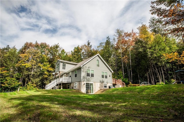 view of side of home featuring a lawn and a deck