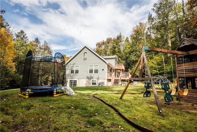 back of house with a playground, a trampoline, and a lawn