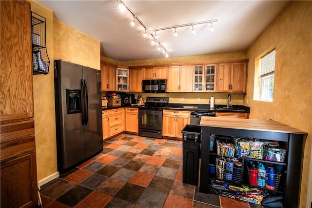 kitchen with sink, rail lighting, and black appliances