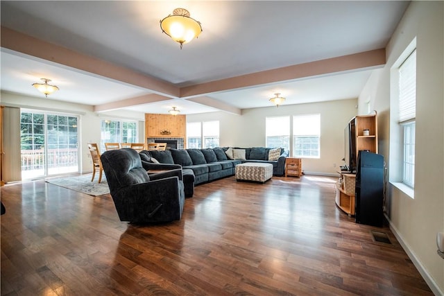 living room featuring beam ceiling and dark hardwood / wood-style flooring