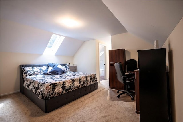 bedroom with connected bathroom, light carpet, and vaulted ceiling