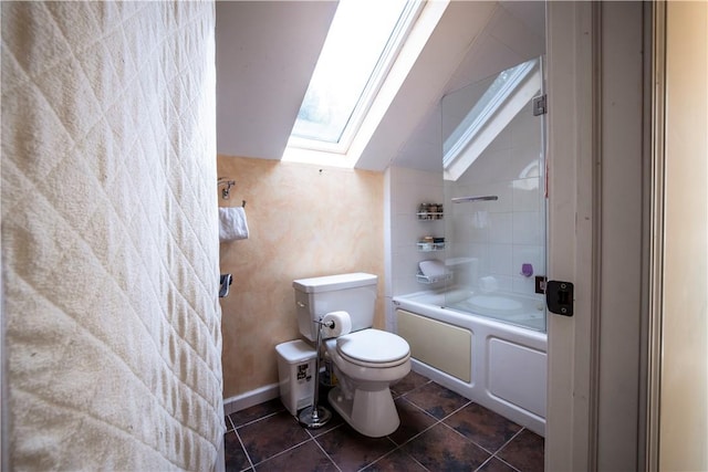 bathroom featuring tile patterned flooring, shower / bath combination, toilet, and vaulted ceiling with skylight