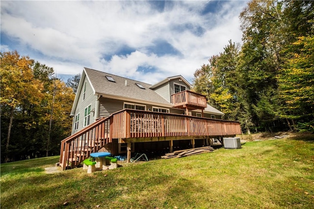 rear view of house with a lawn, cooling unit, and a wooden deck