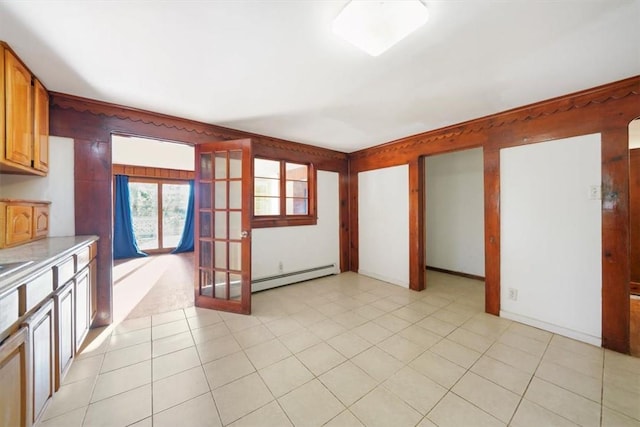 unfurnished living room with french doors, a baseboard heating unit, and light tile patterned flooring