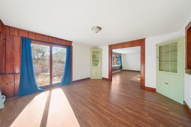 unfurnished room featuring dark wood-type flooring