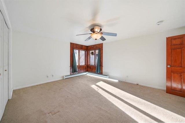 spare room featuring light colored carpet and ceiling fan