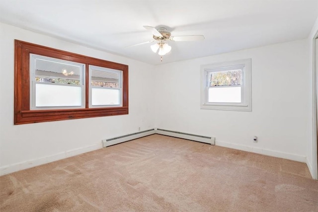 carpeted empty room featuring baseboard heating and ceiling fan