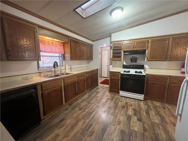 kitchen featuring white gas range, sink, black dishwasher, dark hardwood / wood-style flooring, and vaulted ceiling with skylight