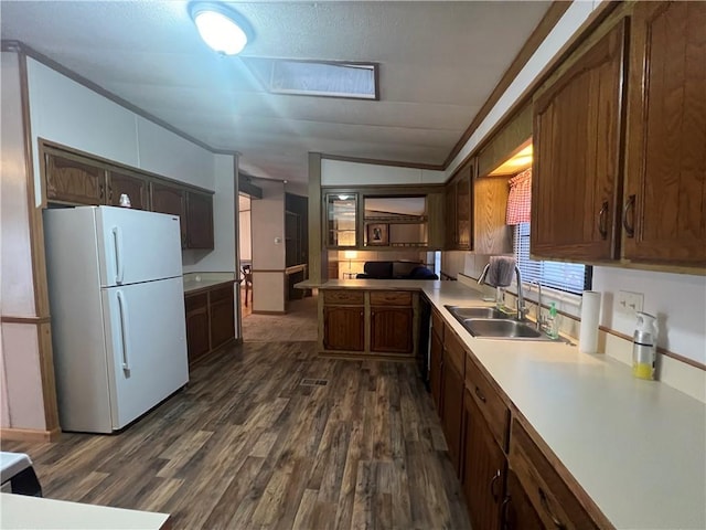 kitchen with white fridge, dark hardwood / wood-style flooring, sink, and vaulted ceiling