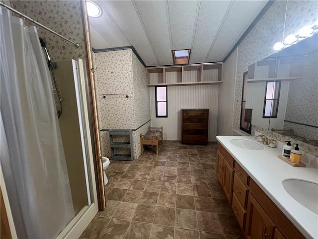 bathroom with walk in shower, vanity, toilet, and a wealth of natural light