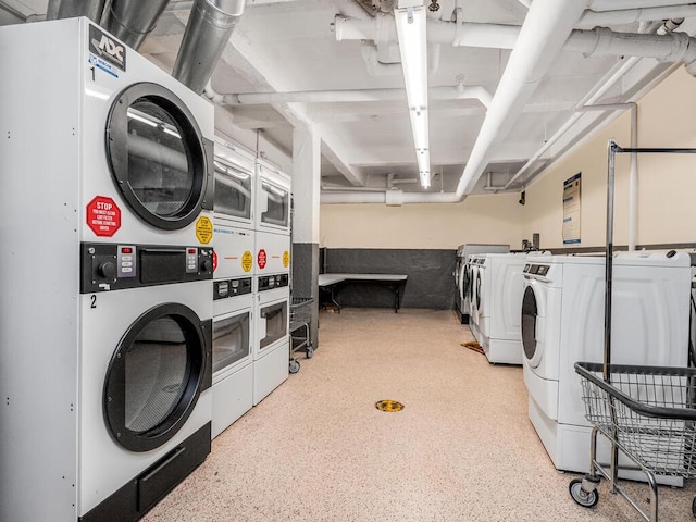 washroom with washing machine and dryer and stacked washing maching and dryer