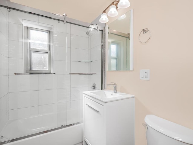 full bathroom with vanity, toilet, and tiled shower / bath