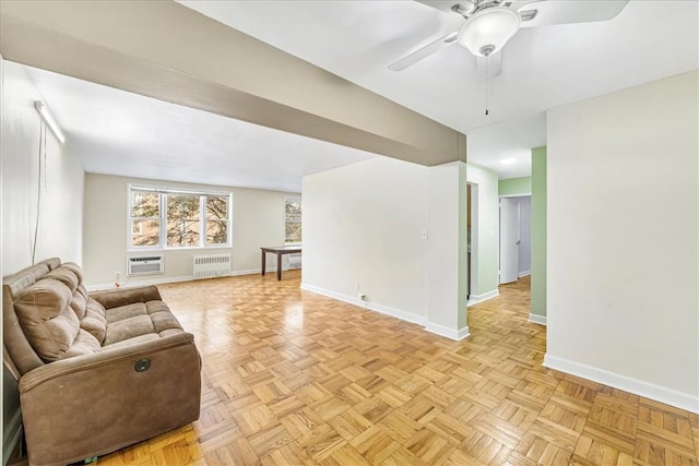 living room with an AC wall unit, radiator, ceiling fan, and light parquet floors