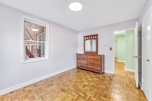 unfurnished bedroom with light parquet flooring