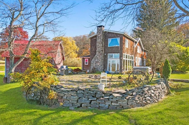 rear view of house with a yard