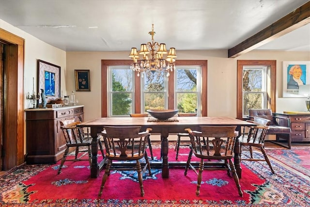 dining area with a notable chandelier, plenty of natural light, and beam ceiling