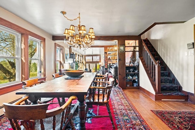 dining area with a chandelier and hardwood / wood-style flooring