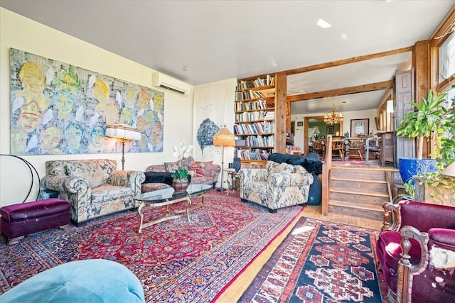 living room with a notable chandelier, wood-type flooring, and a wall unit AC