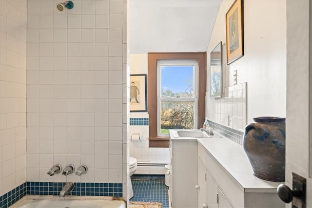 full bathroom featuring tiled shower / bath combo, vanity, a wealth of natural light, and a baseboard heating unit